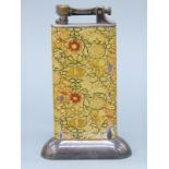 A Dunhill enamelled table lighter with floral decoration,