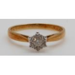 An 18ct gold ring set with a round cut diamond in a star setting, 2.