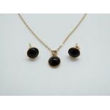 A 9ct gold pendant set with onyx and matching earrings