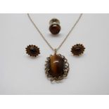 A 9ct gold pendant set with tiger's eye and matching earrings