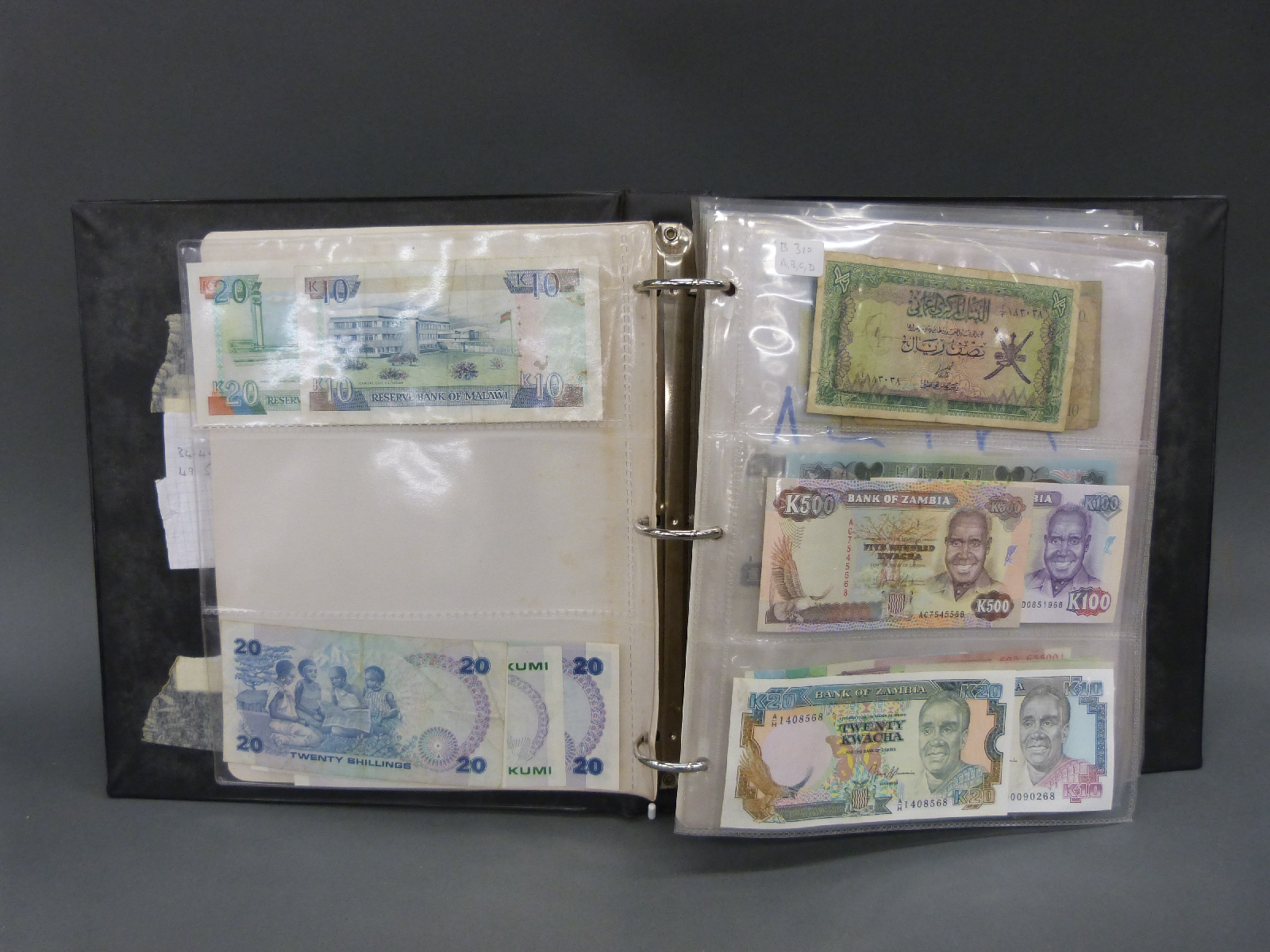 A collection of world bank notes in an album, approximately 180 in all, many uncirculated,