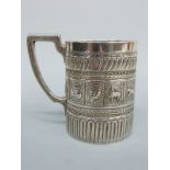 A Victorian hallmarked silver mug with Egyptian revival or Indian/Eastern decoration,