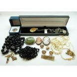 A large collection of costume jewellery to include faux pearls, brooches, chains,