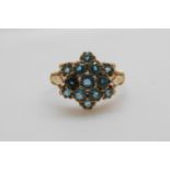 A 9ct gold ring set with blue topaz in a cluster (size N)