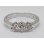 An 18ct white gold ring set with three diamonds, total 0.5ct, 3.