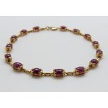 A 9ct gold bracelet set with rubies