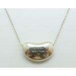 A Tiffany & Co silver necklace by Elsa Peretti in the bean design
