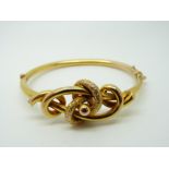 A 9ct gold Victorian bangle with textured knotted design, 10.