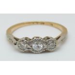 An 18ct gold ring set with three diamonds in a platinum setting, 2.