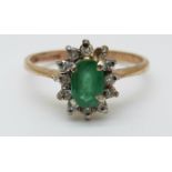A 9ct gold ring set with an emeralds in a cluster