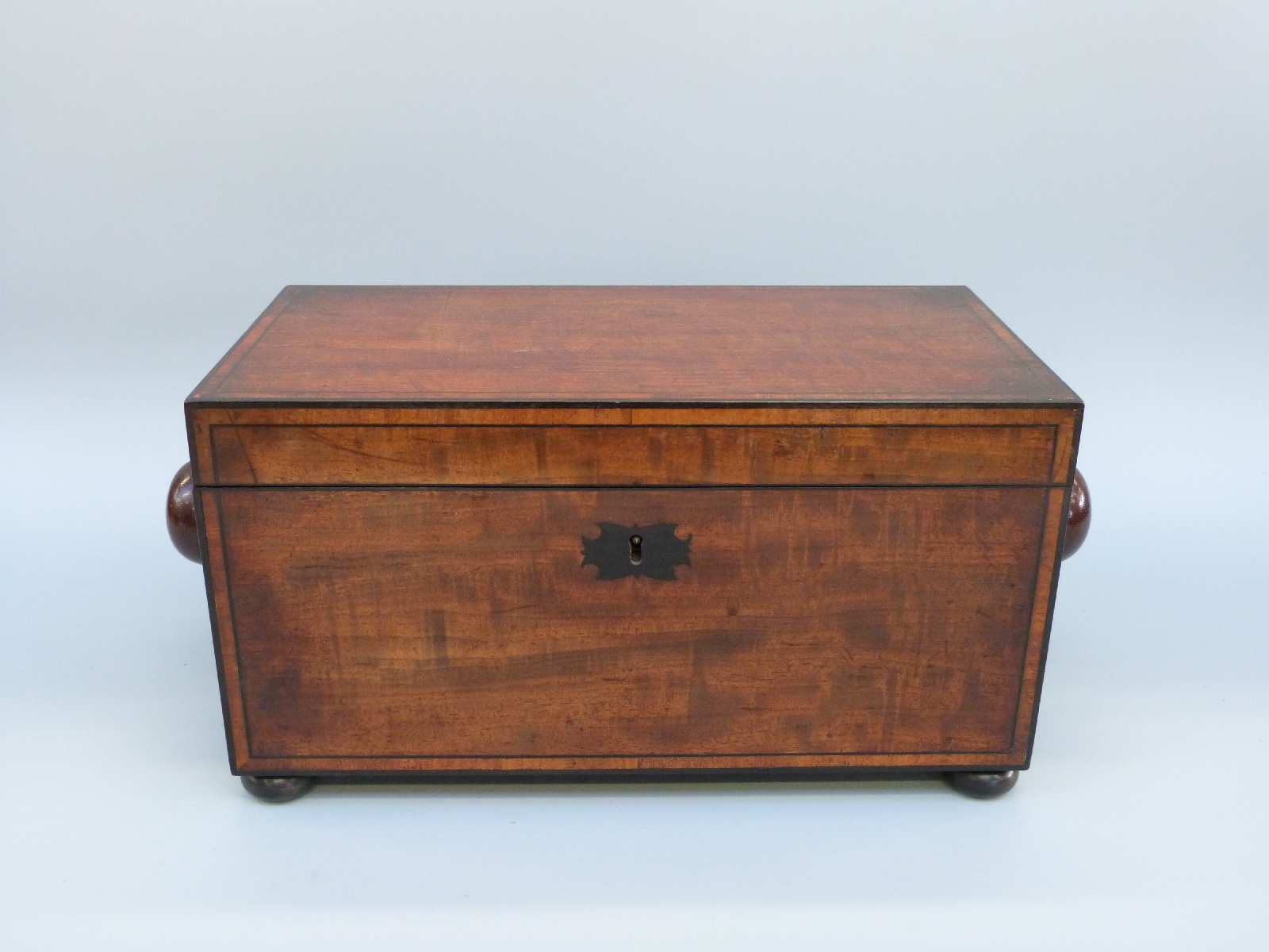 An early 19thC mahogany tea caddy of rectangular form with inlaid ebony detail, raised on bun feet, - Image 5 of 8