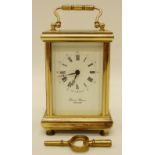 A late 20thC English brass carriage clock with enamelled dial, Roman numerals and Arabic minutes,