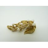 A Grosse 18ct gold brooch with textured detail set with pearls in a textured setting