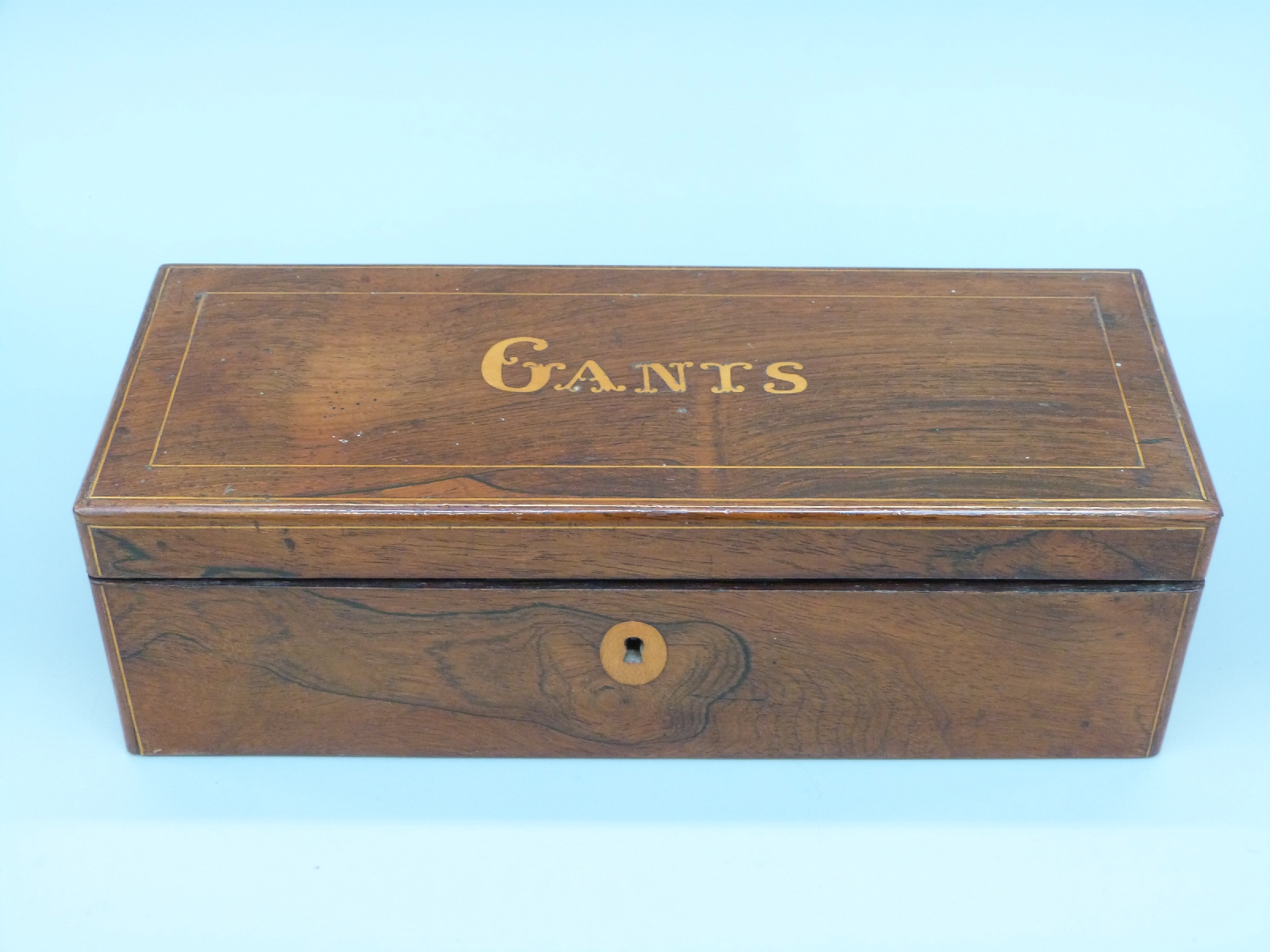 A 19thC French inlaid rosewood glove box with hinged lid and fall flap,