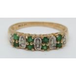 A 9ct gold ring set with a emeralds and diamonds (size P)