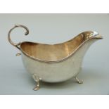 An American white metal sauce boat raised on three feet, marked to underside Birks Sterling 85,