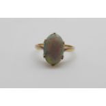 An 18ct gold ring set with an opal cabochon (size I/J)