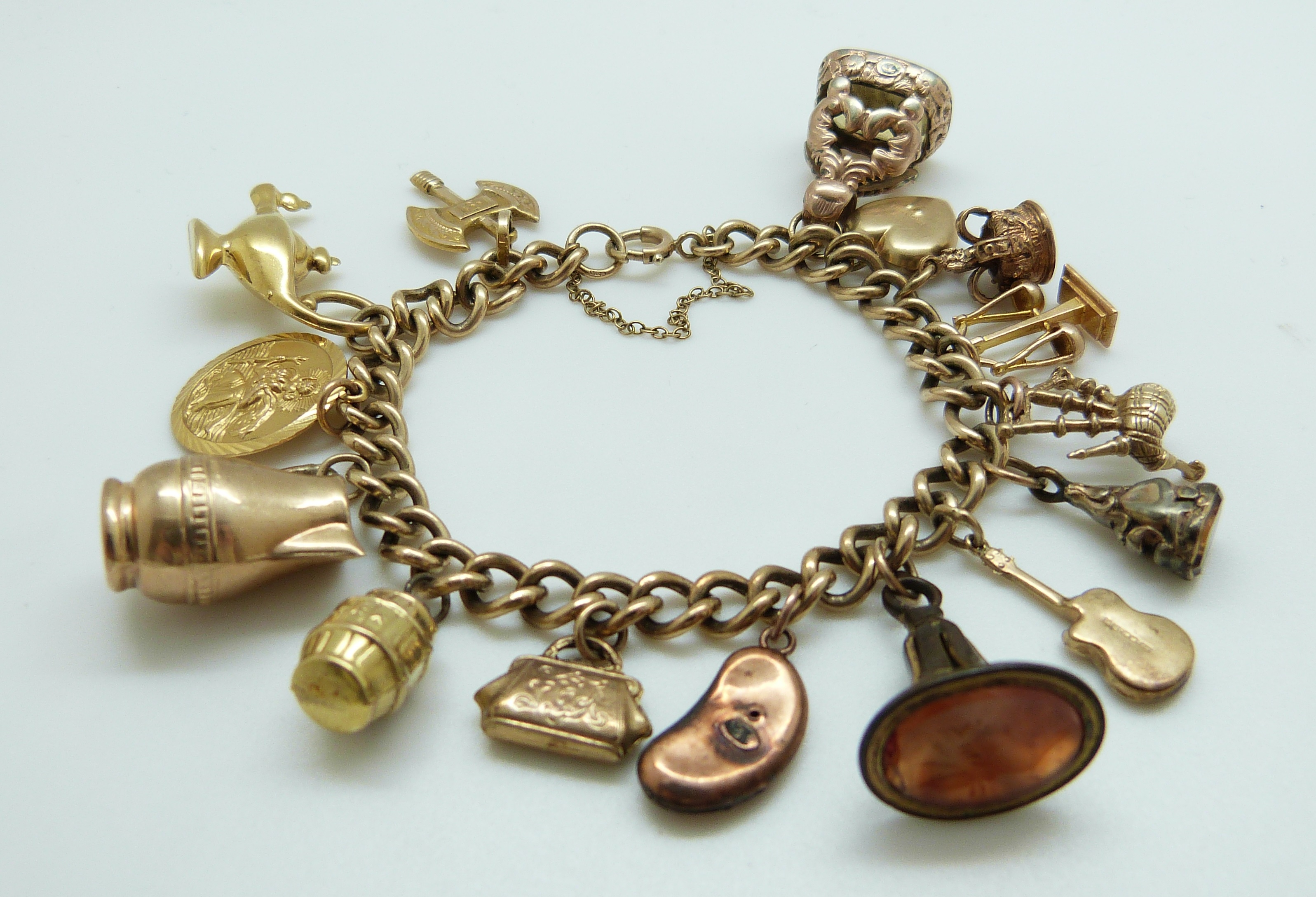 A 9ct gold charm bracelet with eleven 9ct gold charms including a crown, St Christopher, purse, - Image 3 of 8