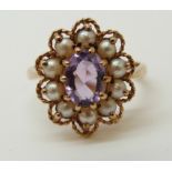 A 9ct gold ring set with an amethyst and surrounded with pearls (size N)