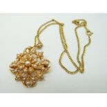 An Edwardian 15ct gold brooch / pendant set with seed pearls on a 9ct chain, 12.