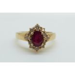 An 18ct gold ring set with an oval cut ruby of approximately 0.75ct surround by diamonds, 4.