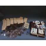 A quantity of mainly copper coins together with sets of 1930s cigarette cards in an oak box,