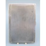 An Art Deco hallmarked silver engine turned cigarette case,