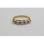 A French 18ct gold ring set with five pearls, 1.