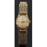 Omega 9ct gold ladies wristwatch with gold hands and markers, on 9ct gold bracelet,