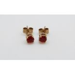 A pair of 9ct gold earrings set with fire opals