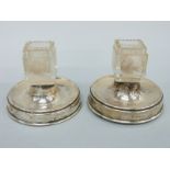 A pair of George V hallmarked silver and cut glass table match safes / lighters,