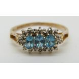 A 9ct gold ring set with blue topaz surrounded by diamonds