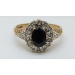 A 9ct gold ring set with an oval sapphire surrounded by diamonds (size M)