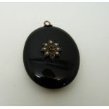 A Victorian French jet pendant set with pearls verso a glass compartment,