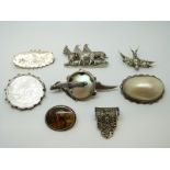 An Edwardian silver brooch with bird and foliate design, a Victorian swallow brooch,