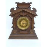 Late 19th century mantel clock in gingerbread style oak case with gold coloured Arabic dial,