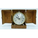 A French DEP "Savoy" travel alarm, the round silvered dial with stylised Arabic numerals,