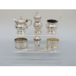 An Edward VIII three piece Harrods cruet set, Birmingham 1936, two napkin rings, a small pepper,