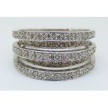 A 9ct white gold ring set with diamonds in layered bands, total diamond weight approximately 1ct, 7.