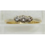 An 18ct gold ring set with three diamonds in a platinum setting, 2.