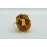 An 18ct gold ring set with a mixed cut natural untreated yellow sapphire measuring approximately