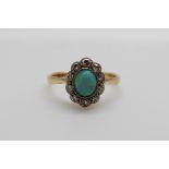 An 18ct gold ring set with a black opal surrounded by old cut diamonds in a platinum setting (size