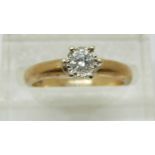 An 9ct gold ring set with a round cut diamond of approximately 0.2ct, 2.