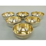 A set of six George V hallmarked silver finger bowls with gilt wash interiors and beaded rims,