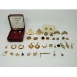 A collection of 9ct gold earrings including a pair set with pearl and a quantity of 9ct gold studs,