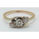 An 18ct gold ring set with three diamonds in a twist setting, the largest diamond approximately 0.