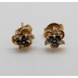 A pair of 18ct gold earrings set with sapphires and diamonds