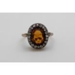 A Victorian ring set with an oval cut citrine surrounded by rose cut diamonds (size P)