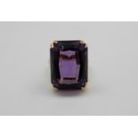 An 18ct gold ring set with a large emerald cut amethyst, 13.