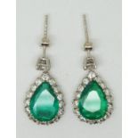 A pair of 18ct gold earrings set with a pear cut apple green emerald to each measuring approx 2ct,
